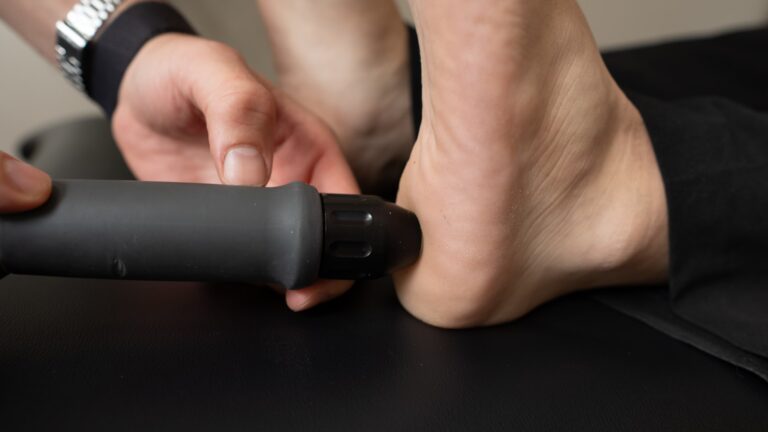 Close-up of a person receiving heel pain treatment at a podiatry clinic in Sydney