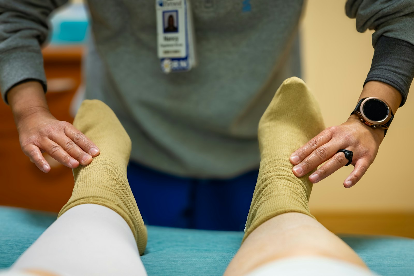 Healthcare worker examining a patient foot for fungal nail treatment in Sydney podiatry clinic