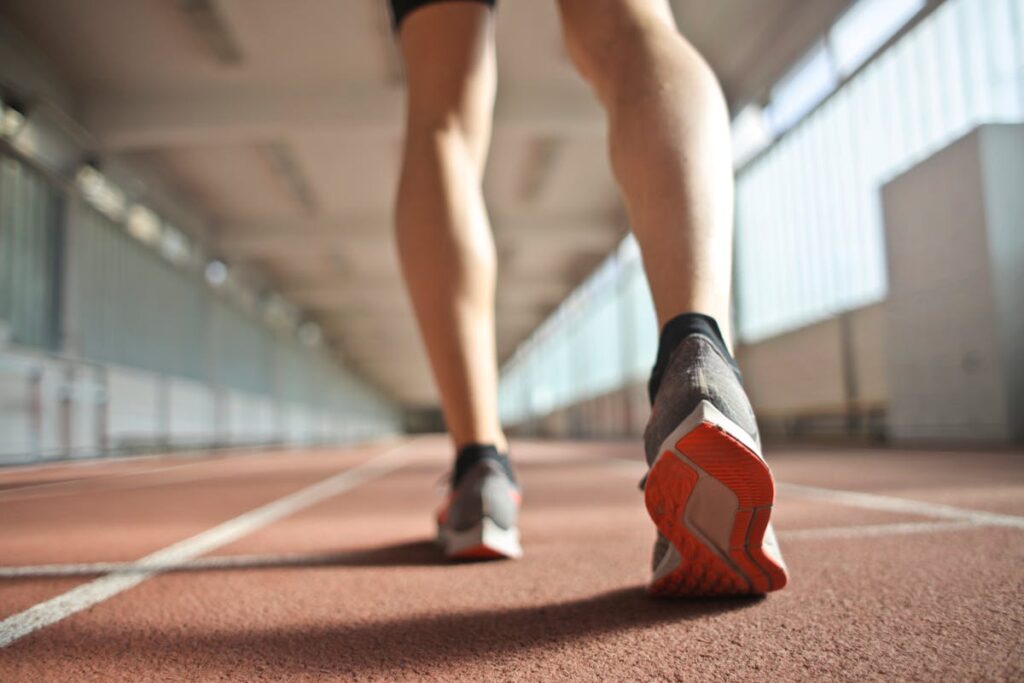 Close-up of runner feet in running shoes on athletic track - toenail fungus risk for athletes in Sydney