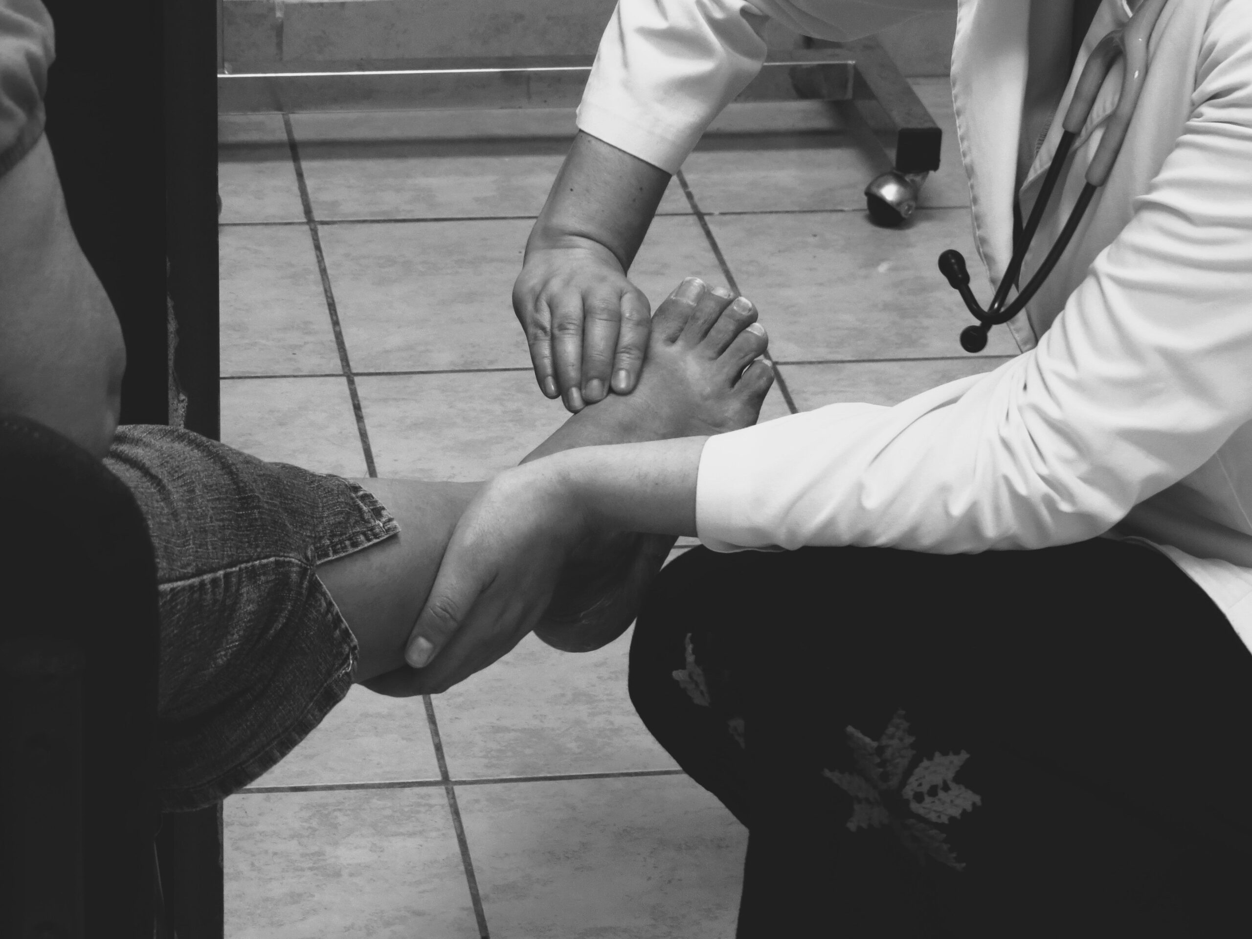 Podiatrist examining a patient foot during consultation in Sydney clinic - private health insurance for podiatry