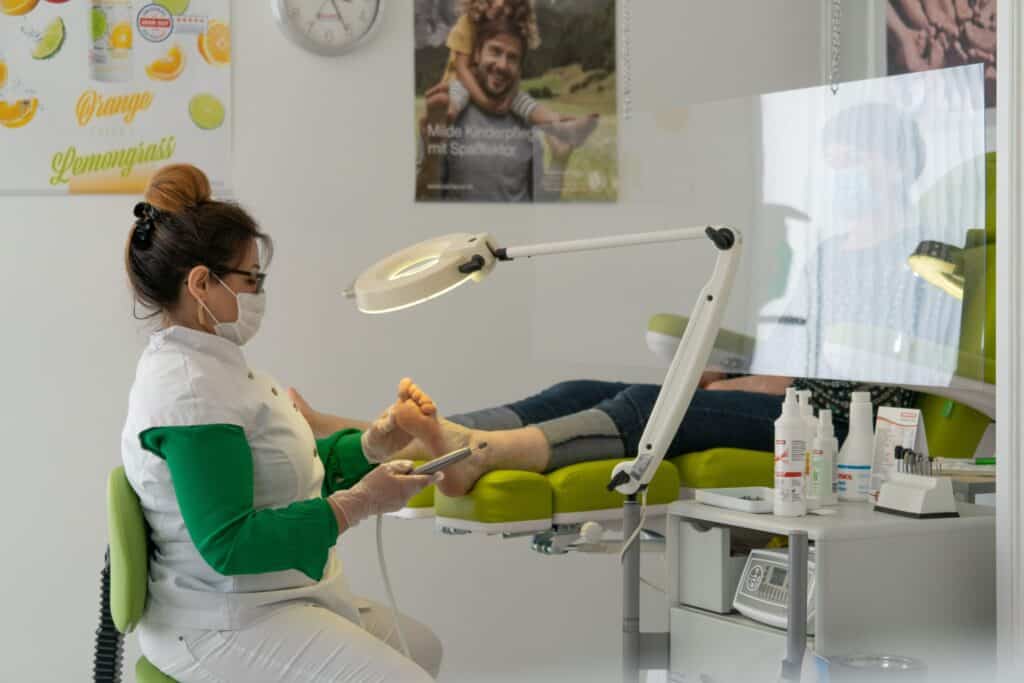 Podiatrist providing foot care treatment to patient during Achilles tendon assessment in Sydney