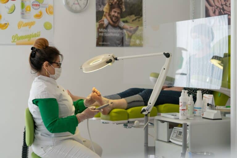 Podiatrist providing foot care treatment to patient during Achilles tendon assessment in Sydney