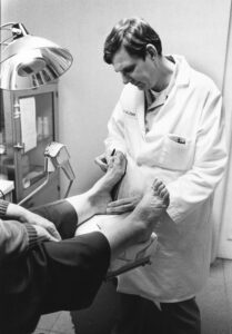 Podiatrist examining a patient's foot and toe joint during hammer toe assessment in Sydney