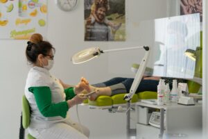 Podiatrist fitting custom orthotics and examining a patient foot in a Sydney clinic