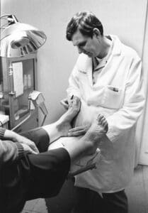 Podiatrist examining a patient foot and ankle in a clinical setting Sydney